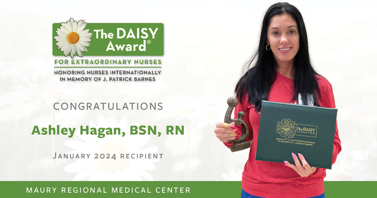 Photo of Ashley Hagan holding the DAISY Award.